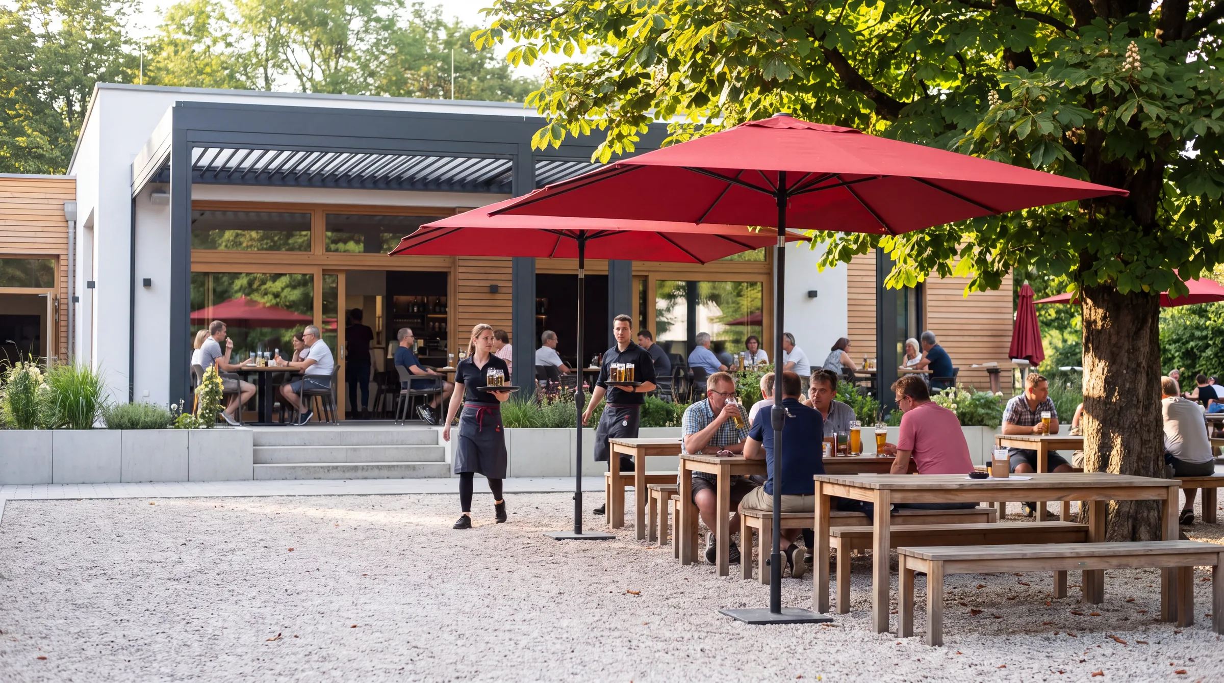 Restaurantterrasse mit Großschirmen und besetzten Tischen an einem Sommerabend
