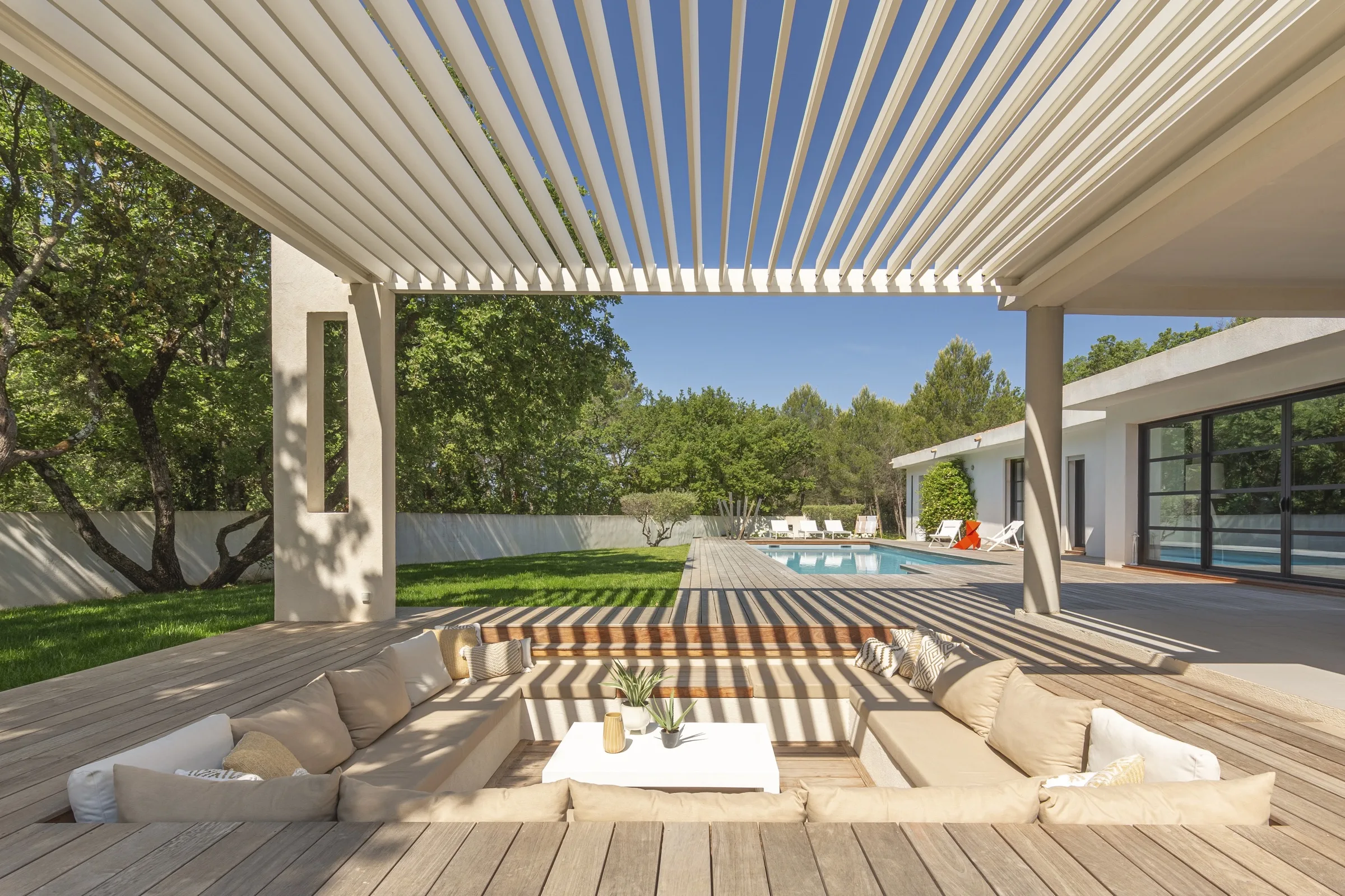 Renson-Lamellendach über einer Terrasse mit Pool im Grünen